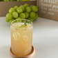 Shine Muscat sparkling juice in a tall glass with ice, mint leaf garnish