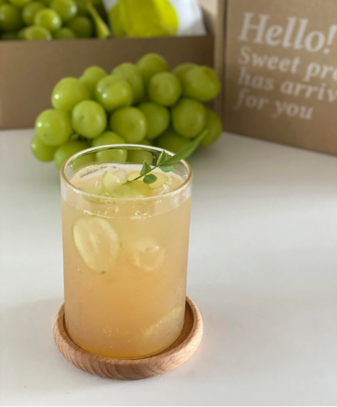 Shine Muscat sparkling juice in a tall glass with ice, mint leaf garnish