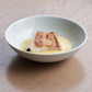Light gray round ceramic salad bowl with food inside