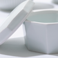 White square porcelain lidded container with lid propped open
