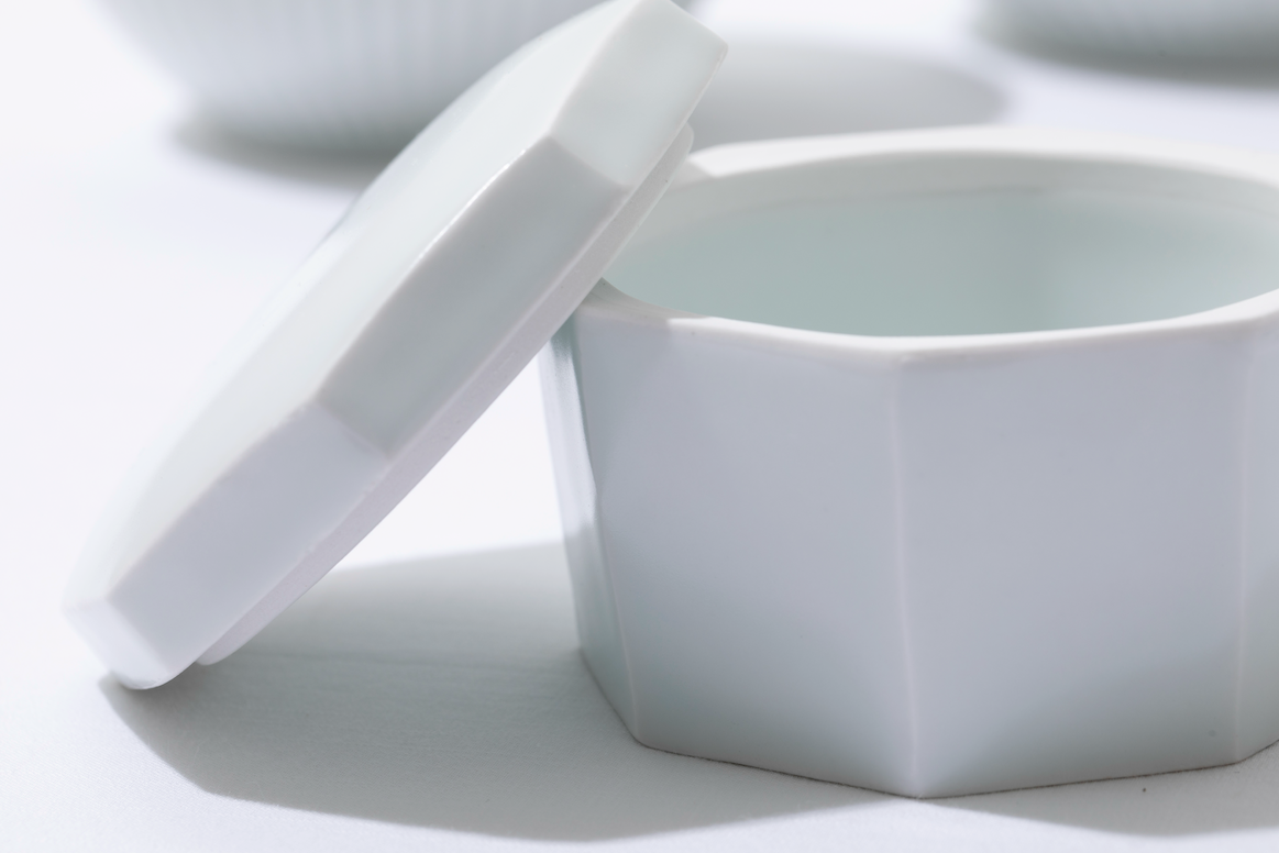 White square porcelain lidded container with lid propped open