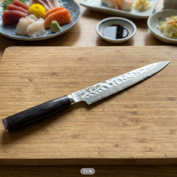 Pairing knife on a wooden cutting board with decorative textured metal blade