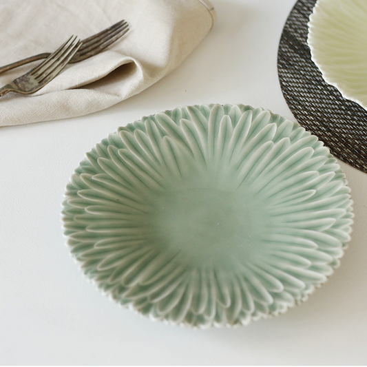 Celadon round plate with radial fan texture and scalloped edge