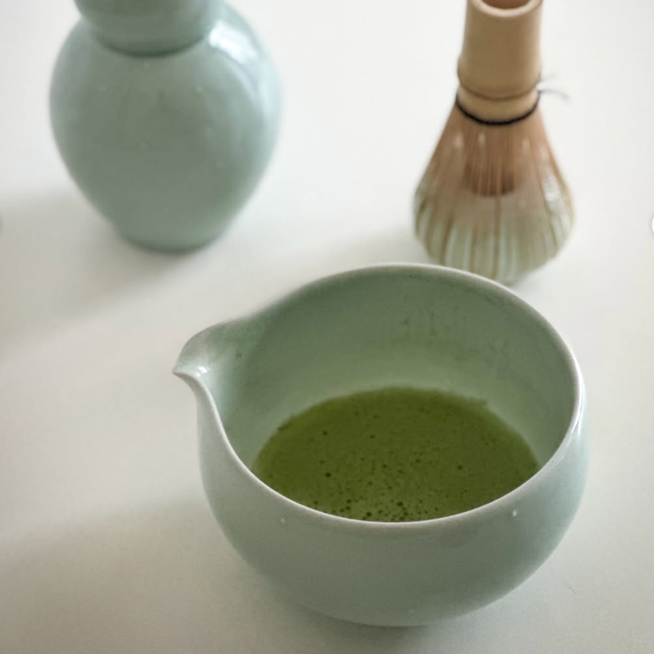 Jade green ceramic matcha bowl with green tea inside