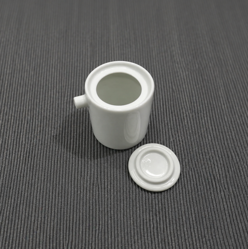 White ceramic candle jar with matching circular saucer and side spout