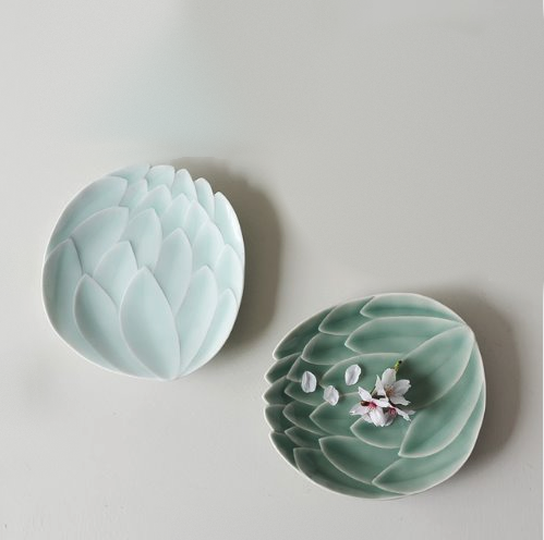 Two lotus dessert plates: sky blue and celadon green with flower garnish