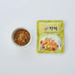 Curry powder pack (green) with ground spice in small bowl