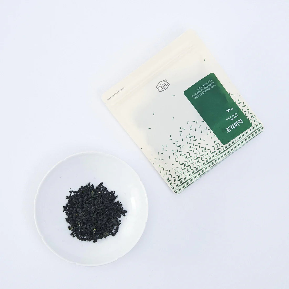 Miyeok-guk kit: green-and-white pouch with dried seaweed in bowl
