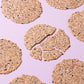 Round crispy black rice taro chips in a scattered pattern