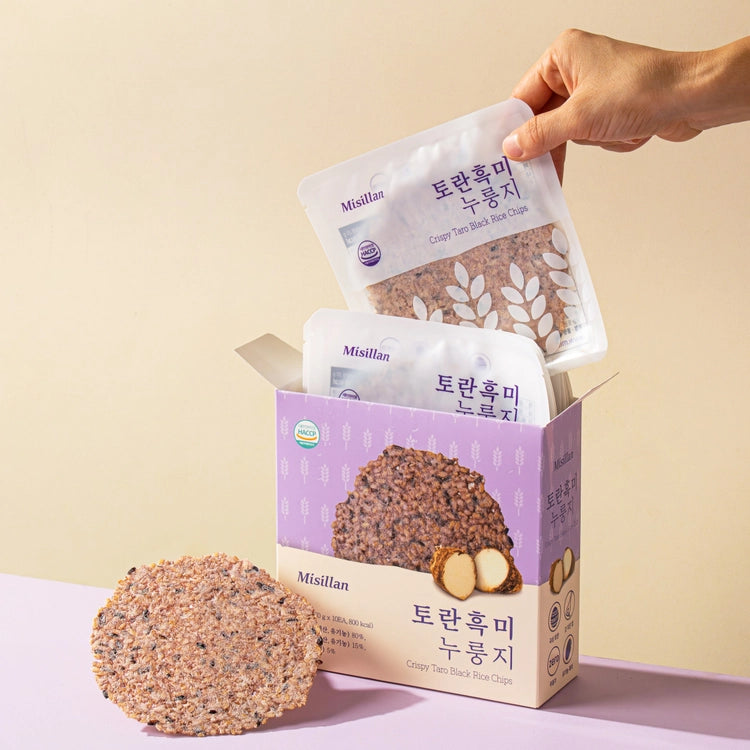 Black rice taro chip pouch in hand with chips and purple box