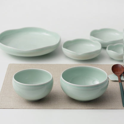 Ceramic rice and soup bowl set in pale sage green, with several matching bowls