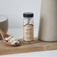 Miyeok-guk kit: clear jar of tablets with wooden spoon of white tablets