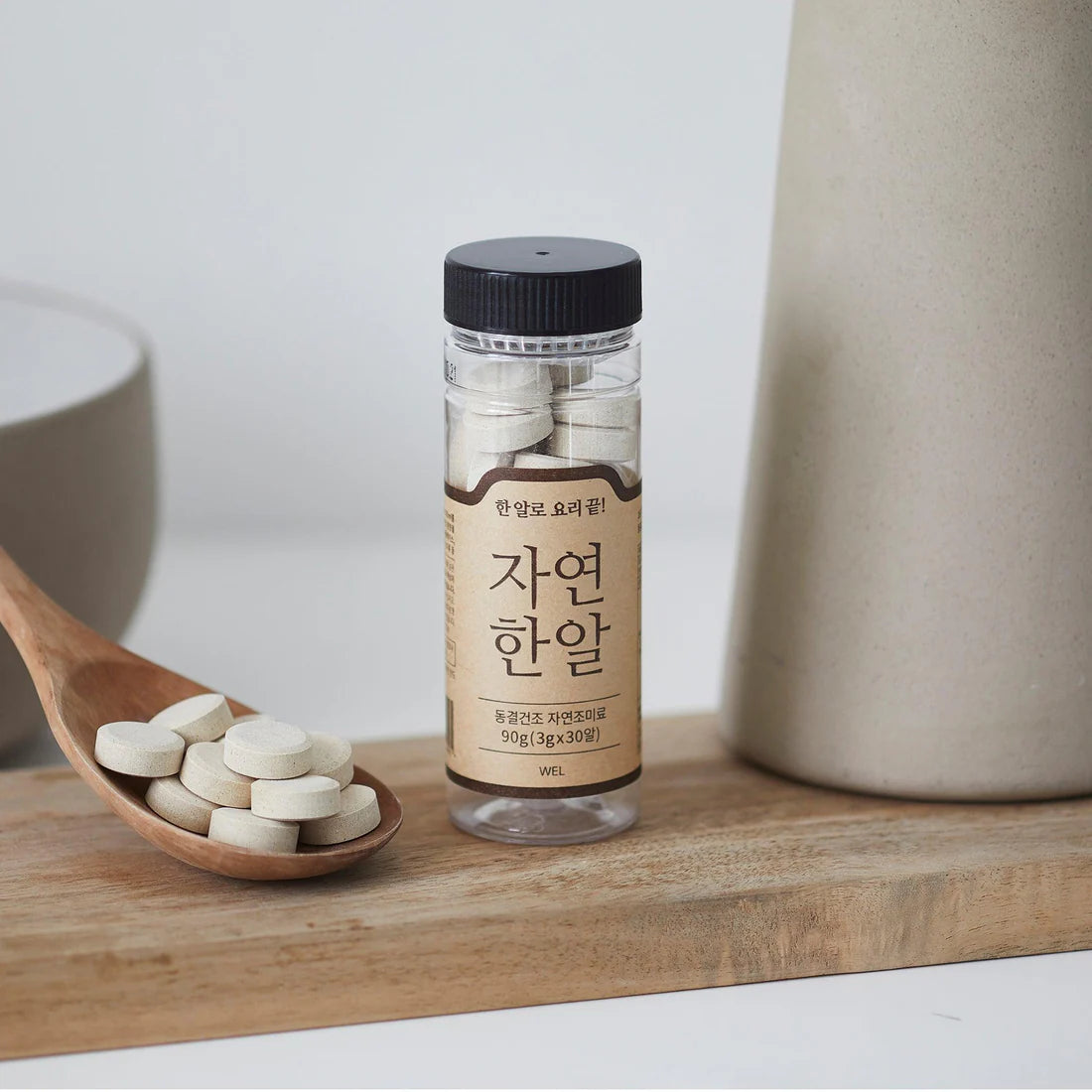Miyeok-guk kit: clear jar of tablets with wooden spoon of white tablets