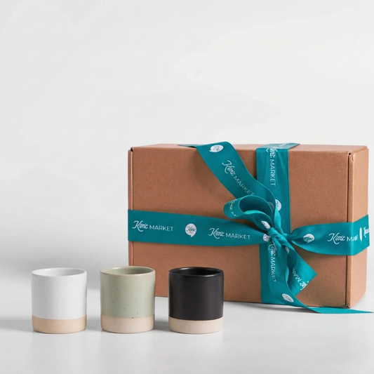 Shot cup gift set with three ceramic cups: white, muted green, and dark charcoal.