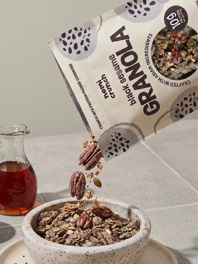 Earl Grey Yuzu granola bag with bowl of granola and a glass bottle nearby