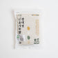 Organic rice bag, white with green and gold circle accents, 1 kg