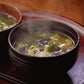 Bowl of miso soup with mushrooms and green onion