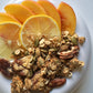 Granola with sliced oranges and oats in a white bowl